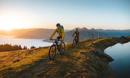 © Fotograf / Kitzbüheler Alpen-Brixental / Mathäus Gartner / Hochgefühl. Wer mit dem Mountainbike hoch hinaus möchte – dort wo die schönsten Aussichten und Trails warten – der sollte auch dafür trainieren. In neue Höhen: Tipps, wie es mit der ersten 1000-Höhenmeter-MTB-Tour sicher klappt